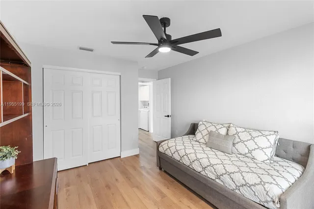a view of a hallway with wooden floor and stairs