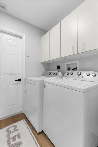 a bathroom with a tub sink double vanity granite and a bathtub