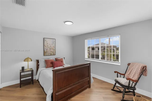 an aerial view of residential houses with outdoor space and ocean view
