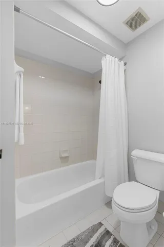 an aerial view of residential houses with outdoor space and ocean view