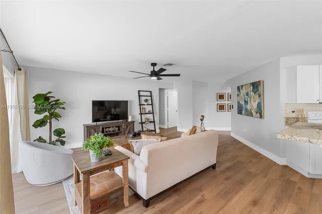 a kitchen with a table chairs microwave and cabinets