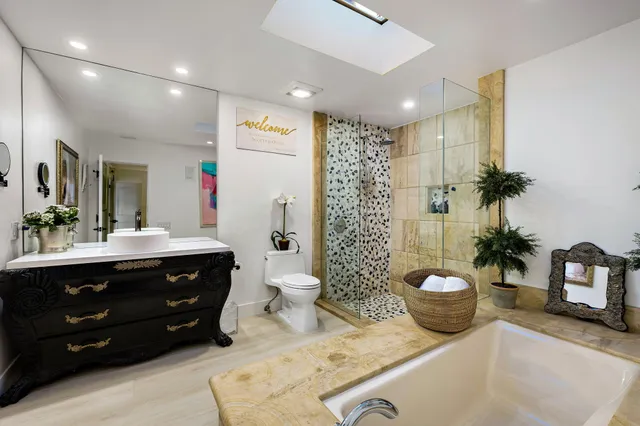 a bathroom with a sink a toilet and shower