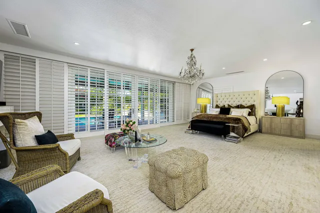 a living room with furniture and large windows
