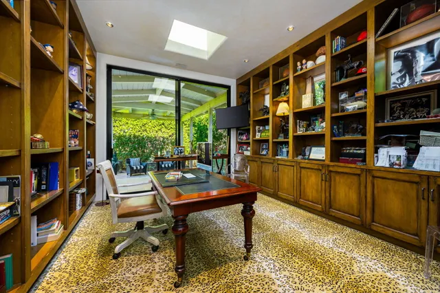 a living room with kitchen island furniture a refrigerator and a table