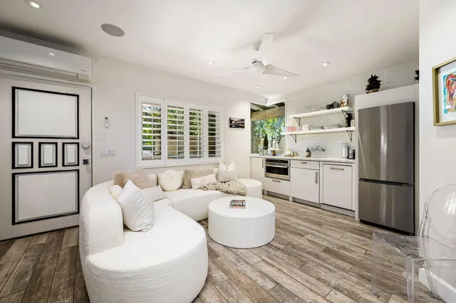 a bedroom with a large bed and a flat screen tv