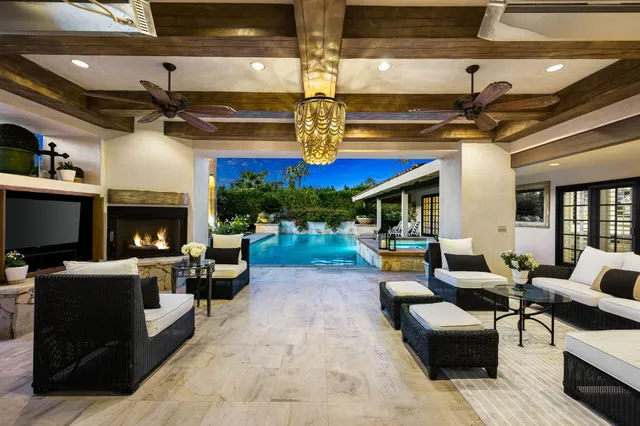 a view of a house with swimming pool and sitting area