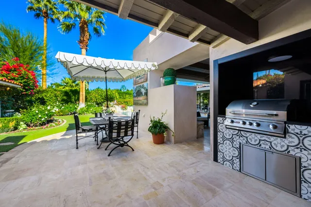 a view of a house with swimming pool and sitting area