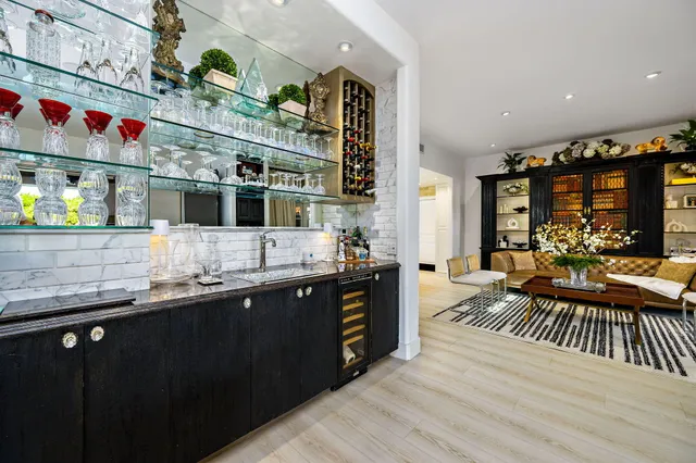 a kitchen with stainless steel appliances granite countertop a sink and wooden cabinets