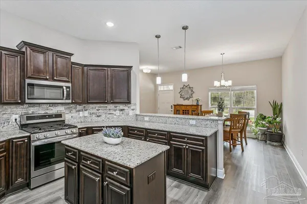 a kitchen with a stove sink and cabinets