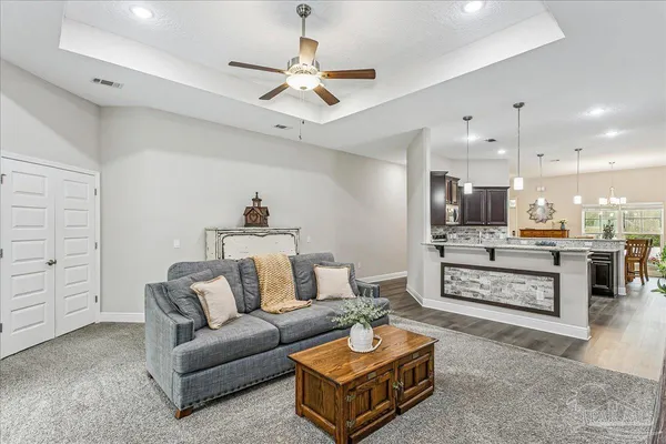 a living room with furniture and kitchen view