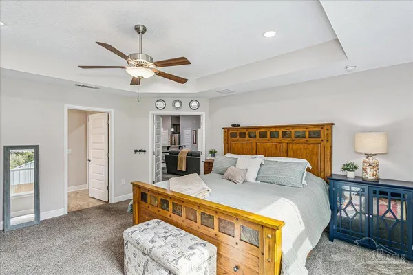 a bedroom with a bed dresser and a window