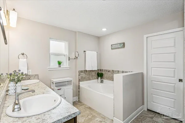 a bathroom with a bathtub and a sink