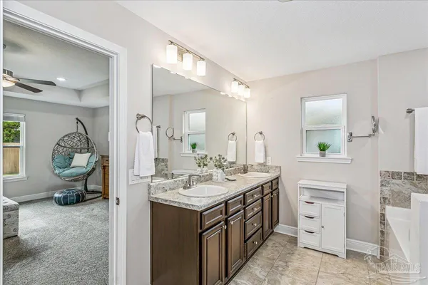 a spacious bathroom with a sink double vanity and a mirror