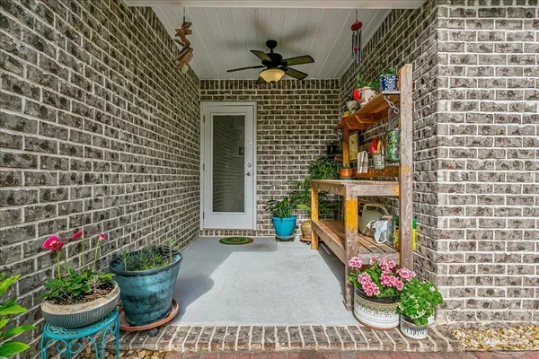 a front view of a house with outdoor seating and flowers