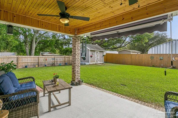 a view of a chair and table in the backyard