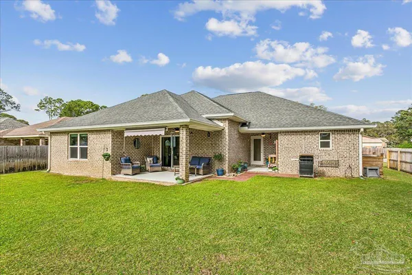 a view of a house with a yard and sitting area