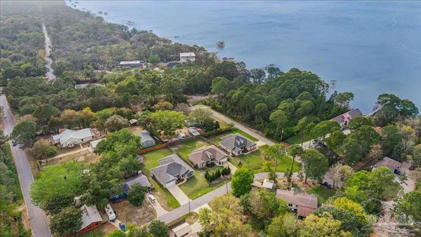 an aerial view of a house with a yard and green space
