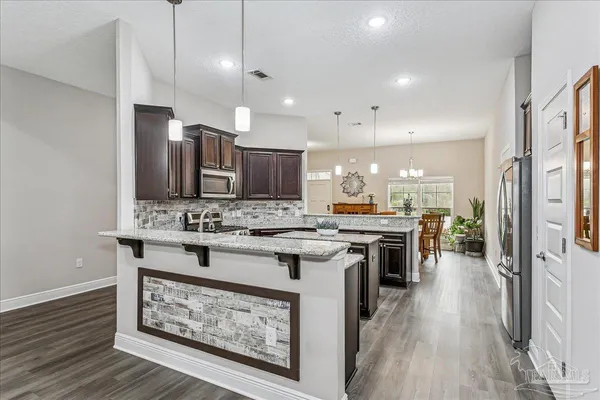 a kitchen with a stove a sink and a refrigerator