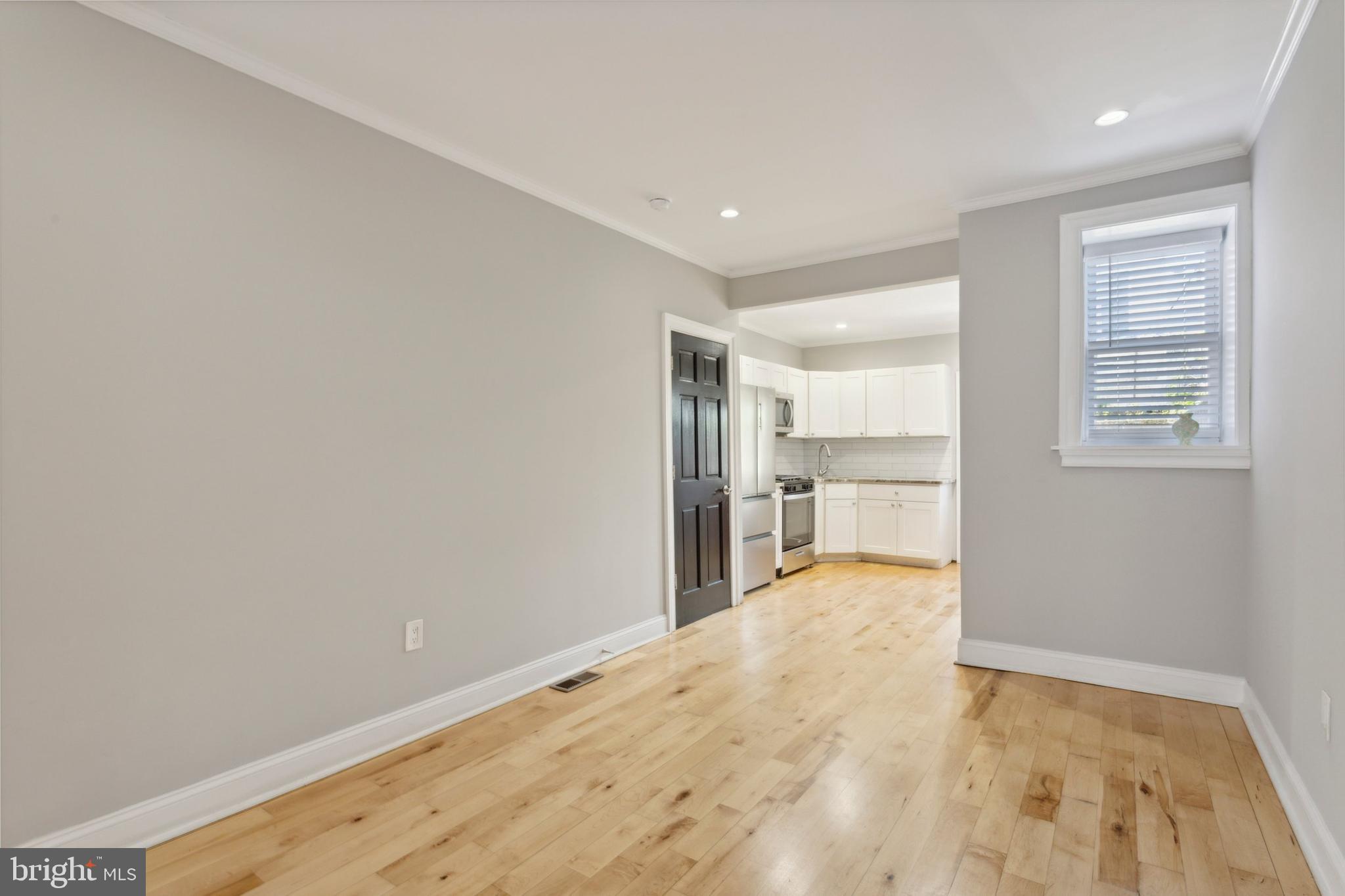 1930 Pierce Street Philadelphia, PA 19145 - Photo 6 of 16 a view of a big room with wooden floor and a window