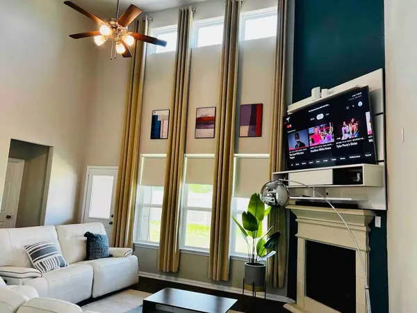 a living room with fireplace furniture and a flat screen tv
