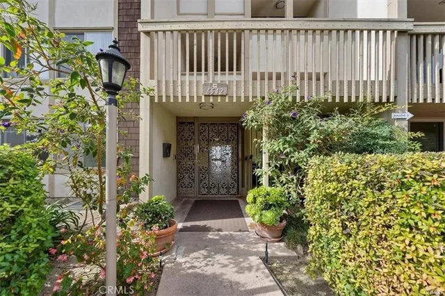 a view of a house with a flower garden