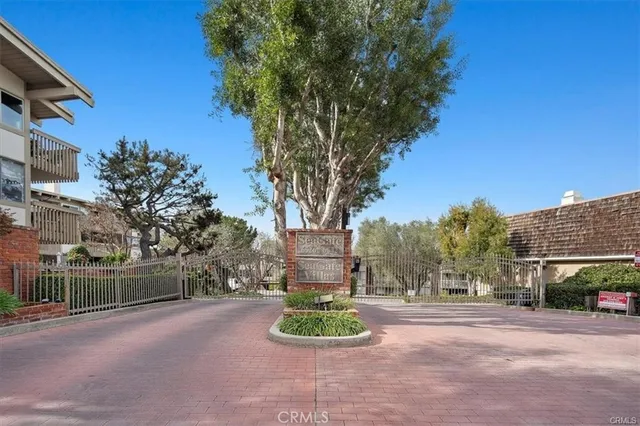 a front view of a house with a yard and tree s