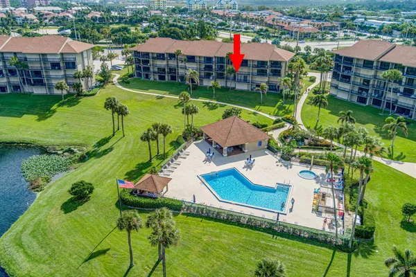 an aerial view of a house with swimming pool garden and lake view