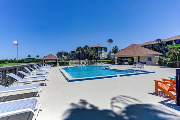 a view of a swimming pool with lounge chairs
