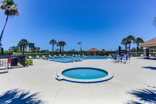 a swimming pool with outdoor seating and yard