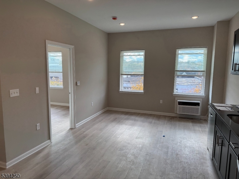 10 East Washington Avenue, Unit 201 Washington, NJ 07882 - Photo 4 of 5 an empty room with windows and cabinet