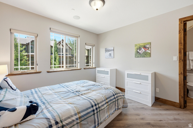 3148 Lower Saddleback Road Park City, UT 84098 - Photo 32 of 67 Room featuring wood-finish flooring, three windows with wood sills, light gray wall paint, and a wood-trimmed doorway