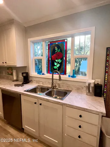 a kitchen with a sink and large window