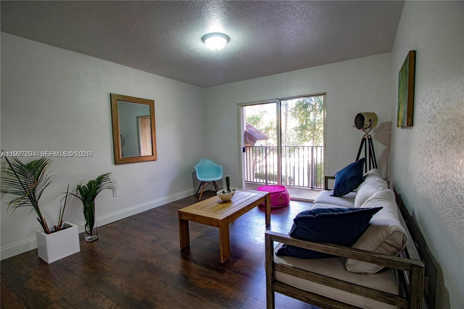 15470 Southwest 284th Street, Unit 3201 Homestead, FL 33033 - Photo 11 of 16 a living room with furniture and a wooden floor