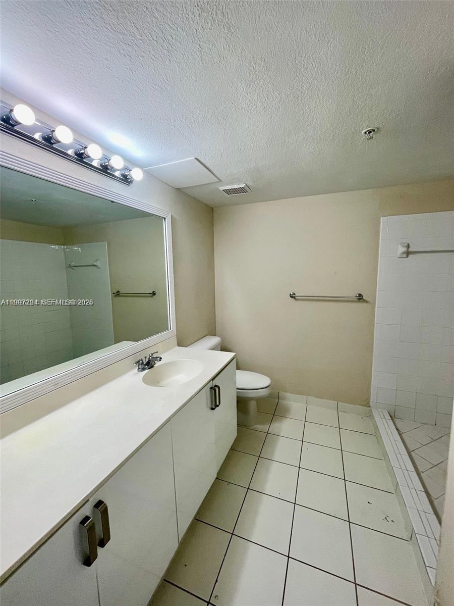 15470 Southwest 284th Street, Unit 3201 Homestead, FL 33033 - Photo 3 of 16 a bathroom with a sink a toilet and a mirror