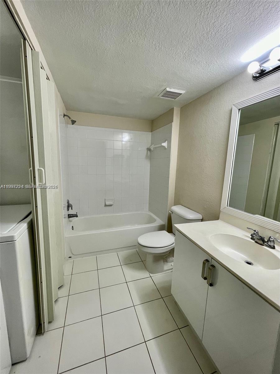 15470 Southwest 284th Street, Unit 3201 Homestead, FL 33033 - Photo 4 of 16 a bathroom with a sink a toilet and shower