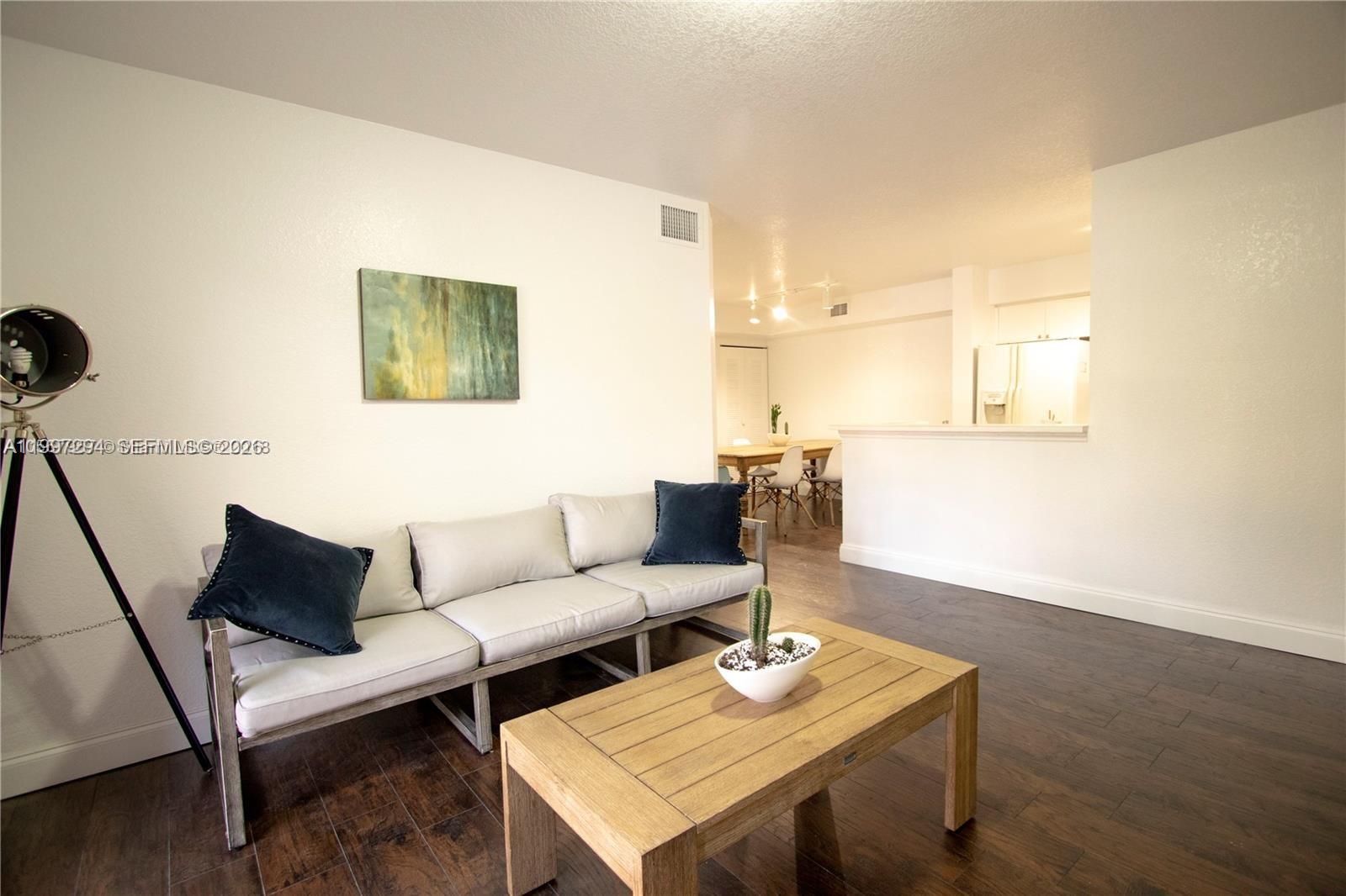 15470 Southwest 284th Street, Unit 3201 Homestead, FL 33033 - Photo 10 of 16 a living room with furniture and wooden floor