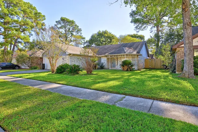 a view of house with yard and green space