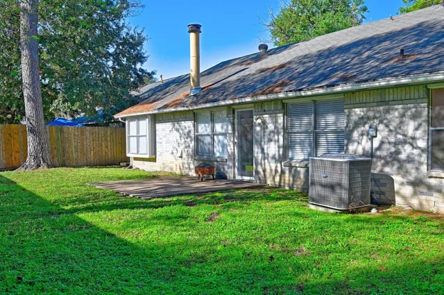 a view of a house with a backyard and a patio