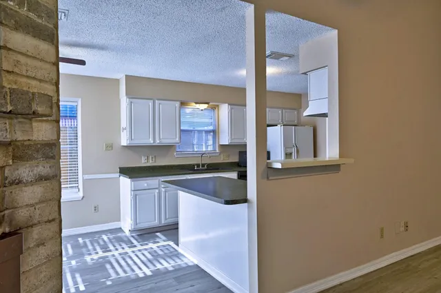 a kitchen with a sink and cabinets