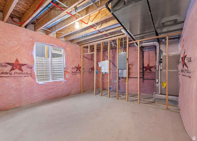 11214 South Easy Bee Road, Unit 270 South Jordan, UT 84009 - Photo 31 of 31 Unfinished lower level featuring an egress window, exposed wood ceiling joists, pink insulation, and framed interior walls