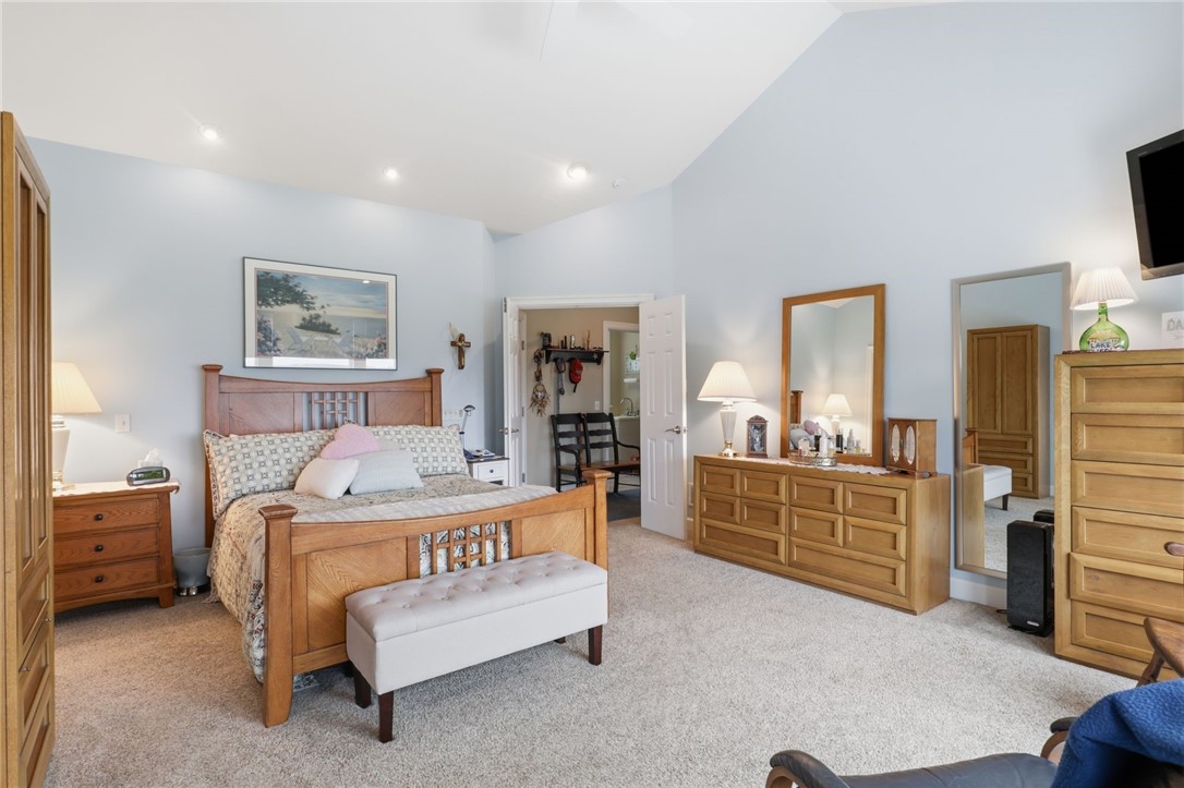 4536 Crystal Ridge Circle Gorham, NY 14424 - Photo 16 of 48 This stunning, expansive primary suite serves as the ultimate peaceful retreat, soaring cathedral ceilings that create an airy and open atmosphere.
