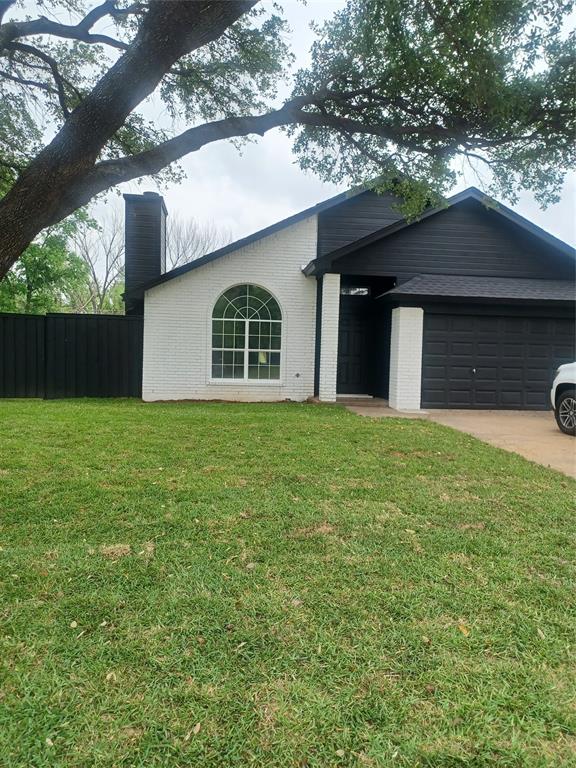 1728 Independence Road Blue Mound, TX 76131 - Photo 1 of 1 Ranch-style house with a chimney, a front yard, fence, brick siding, and a garage