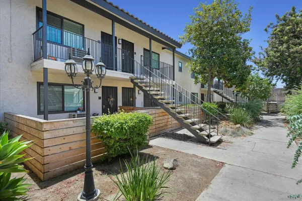 a view of a house with a yard and sitting area