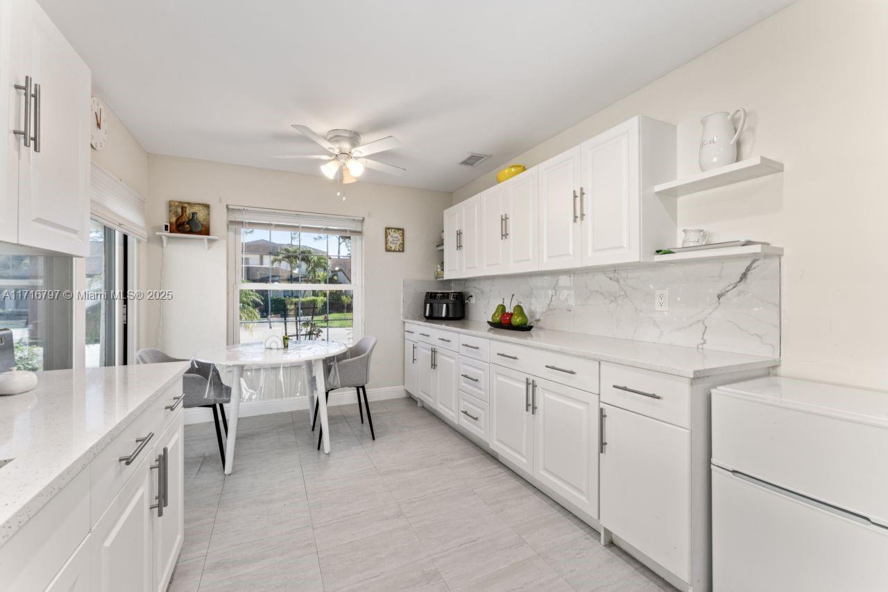 20929 Boca Ridge Drive West Boca Raton, FL 33428 - Photo 13 of 47 a kitchen with cabinets appliances and a window