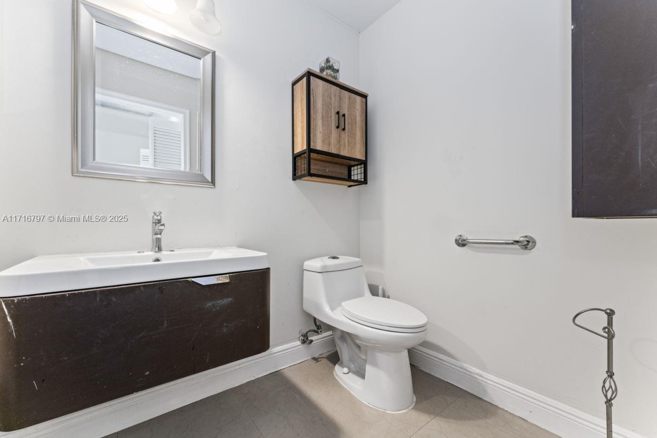 20929 Boca Ridge Drive West Boca Raton, FL 33428 - Photo 18 of 47 a bathroom with a toilet sink and mirror