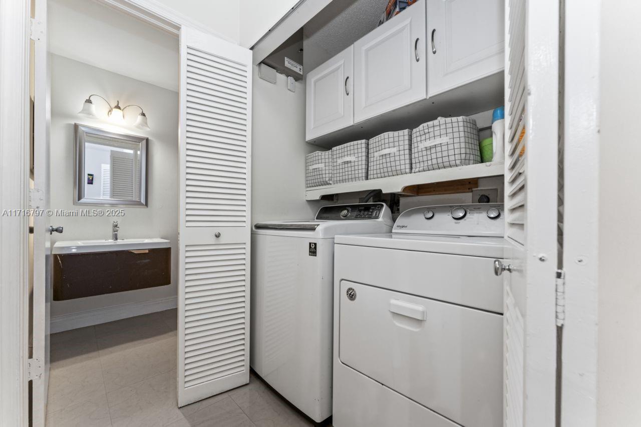 20929 Boca Ridge Drive West Boca Raton, FL 33428 - Photo 19 of 47 a utility room with cabinets washer and dryer
