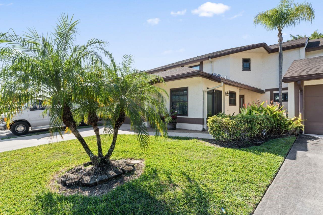 20929 Boca Ridge Drive West Boca Raton, FL 33428 - Photo 2 of 47 a front view of a house with garden