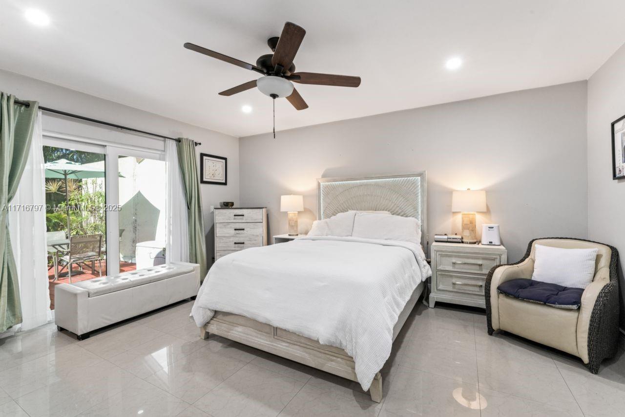 20929 Boca Ridge Drive West Boca Raton, FL 33428 - Photo 23 of 47 a spacious bedroom with a bed and a large window