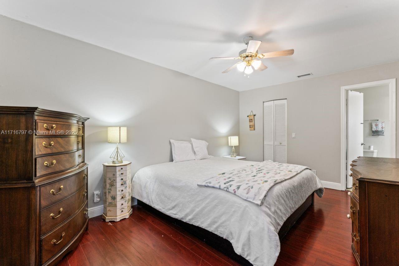 20929 Boca Ridge Drive West Boca Raton, FL 33428 - Photo 26 of 47 a bedroom with a bed and a chandelier