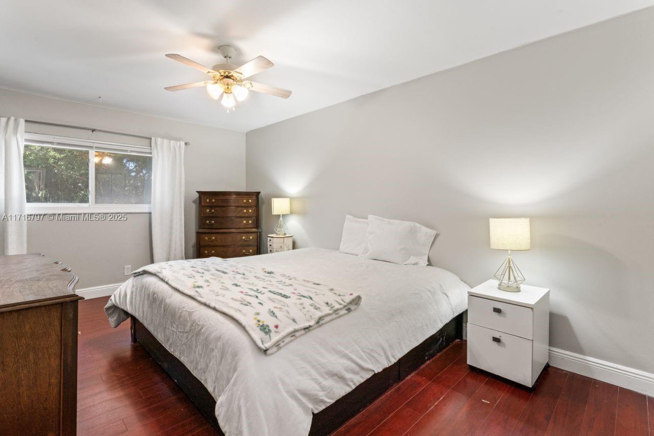 20929 Boca Ridge Drive West Boca Raton, FL 33428 - Photo 27 of 47 a bedroom with a large bed and a chandelier